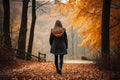 Unrecognizable woman walking on autumn forest nature path, active outdoor trail in woods background Royalty Free Stock Photo