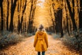 Unrecognizable woman walking on a scenic autumn forest trail surrounded by serene woods