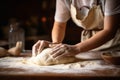 Unrecognizable woman kneading bread dough at a rural table