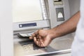 Unrecognizable young african man getting money from ATM Royalty Free Stock Photo