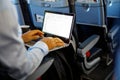 Unrecognizable young businessman with notebook sitting inside an airplane Royalty Free Stock Photo