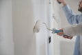 Unrecognizable young couple painting walls in their new house in construction. Royalty Free Stock Photo
