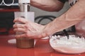 Unrecognizable young caucasian man in apron washing using a blender in a kitchen Royalty Free Stock Photo