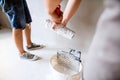 Unrecognizable young couple painting walls in their new house. Royalty Free Stock Photo