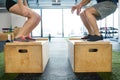 Unrecognizable young fit couple in gym doing box jumps. Royalty Free Stock Photo