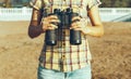 Unrecognizable Young Girl Standing On The Shore And Holding Binoculars Royalty Free Stock Photo