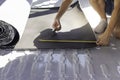 Unrecognizable young man measuring and cutting the rubber isolation roll for the insulation of a camper van convertion Royalty Free Stock Photo