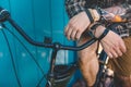 Unrecognizable Young Man Sitting On A Bicycle Near Blue Wall Background Daily Lifestyle Urban Resting Concept