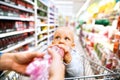 Young mother with her little baby boy at the supermarket. Royalty Free Stock Photo