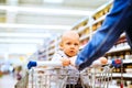 Young mother with her little baby boy at the supermarket. Royalty Free Stock Photo