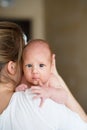 Unrecognizable young mother holding baby son in her arms Royalty Free Stock Photo