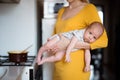 Unrecognizable young mother holding baby son in her arms Royalty Free Stock Photo