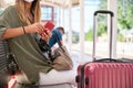 Unrecognizable young woman with her wallet in her hand waiting for the train at a train station Royalty Free Stock Photo