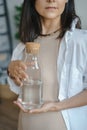 Unrecognizable young woman holding a jug of clean water in her hands. Naturalness, purity and healthy lifestyle concept Royalty Free Stock Photo