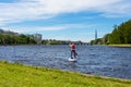 Unrecognizable young woman rowing on a sup board