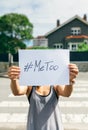 Woman showing poster with metoo hashtag