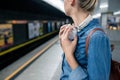 Unrecognizable young woman at the underground platform, waiting Royalty Free Stock Photo