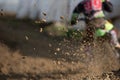 Unrecognized athlete on a motorbike on muddy road during a motocross racing event