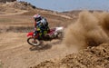 Unrecognized athlete riding a sports motorbike on a motocross racing event. Extreme sports high speed.