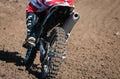 Unrecognized athlete riding a sports motorbike on a motocross racing