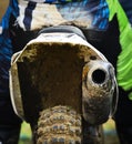 Unrecognized Athlete riding a sports motorbike and muddy wheel