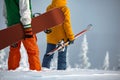 Unrecognized skier and snowboarder couple stands at mountain top Royalty Free Stock Photo