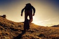 Unrecognized traveler hiker walks in mountains at sunset Royalty Free Stock Photo