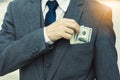 Unrecongnizable Businessman with money in suit Business man putting money in pocket suit Rich guy earn a lot of money and get a Royalty Free Stock Photo