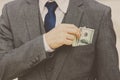 Unrecongnizable Businessman with money in suit Business man putting money in pocket suit Rich guy earn a lot of money and get a Royalty Free Stock Photo