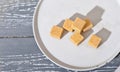 unrefined brown cane sugar cubes on cement plate. stack of natural sweetener for healthy meal, top view Royalty Free Stock Photo