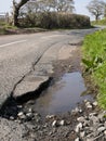 Unrepaired surface damage to tarmac on a rural road Royalty Free Stock Photo