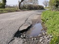 Unrepaired surface damage to tarmac on a rural road Royalty Free Stock Photo