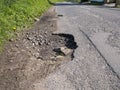 Unrepaired surface damage to tarmac on a rural road Royalty Free Stock Photo