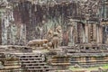 Unrestaured statues of a Cambodian naga, garudas and a lion in the Bayon temple in Angkor Thom Royalty Free Stock Photo