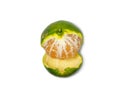 Unripe tangerine. Peeling a tangerine. Green fruit on a white background. Sour ingredient. Citrus isolate