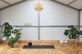Unrolled yoga mat on wooden floor in a fitness center. space for doing sport exercises, meditating, yoga equipment