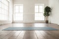 Unrolled yoga mat on wooden floor in yoga studio Royalty Free Stock Photo