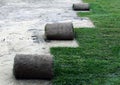 Unrolling Sod for a New Lawn with sprinkler head Royalty Free Stock Photo