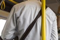 Unsafety man lean on the pole in the train. Royalty Free Stock Photo