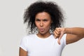 Unsatisfied african woman showing thumb down disapproval gesture Royalty Free Stock Photo