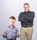 Unsatisfied with work done. childhood. trust and values. fathers day. father and son in business suit. fashion. happy