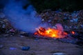 Unscientific burning of garbage in a public place in a late evening