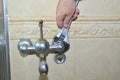 Unscrewing an old bathroom faucet Royalty Free Stock Photo