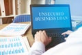 Unsecured Business Loan concept. Man with the laptop