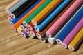 Unsharpened color pencils in a stack on a wooden background Royalty Free Stock Photo