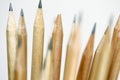 Unsharpened pencil in focus on beam of natural wood pencils Royalty Free Stock Photo