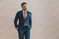 Unshaved businessman in elegant suit looking away Royalty Free Stock Photo