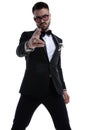 Unshaved dramatic man in tuxedo making gun gesture Royalty Free Stock Photo