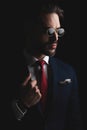 Unshaved fashion model in suit with red tie and retro sunglasses Royalty Free Stock Photo