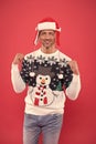 Unshaven man funny sweater red background. male cold weather fashion. santa man ready for winter holiday. xmas party and